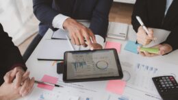 Businessman is reviewing monthly sales documents for analysis and marketing plans for more sales gro